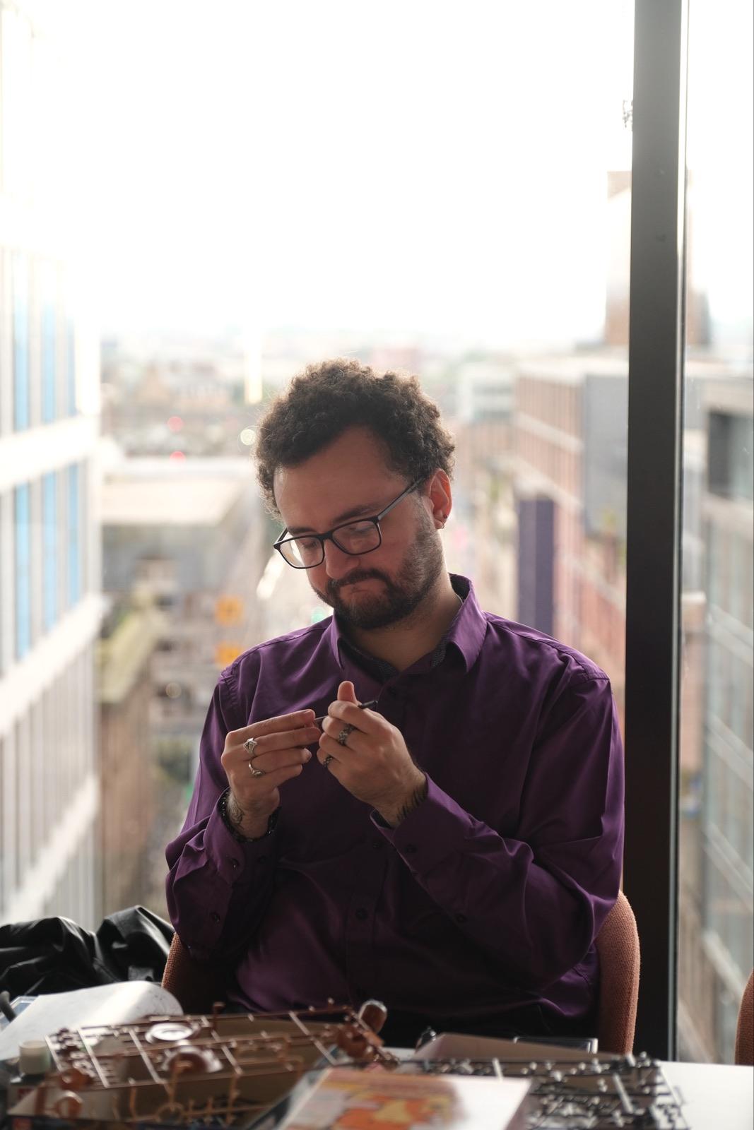 Someone assembling a model kit by the window